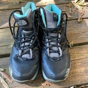 Black and teal North Face boots